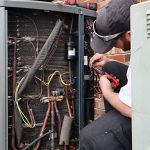 Service repair being done on a heat pump hvac system